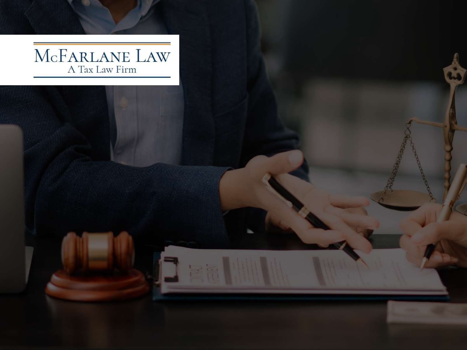 Lawyers discuss legal documents related to Tax Filings at McFarlane Law, a tax law firm.